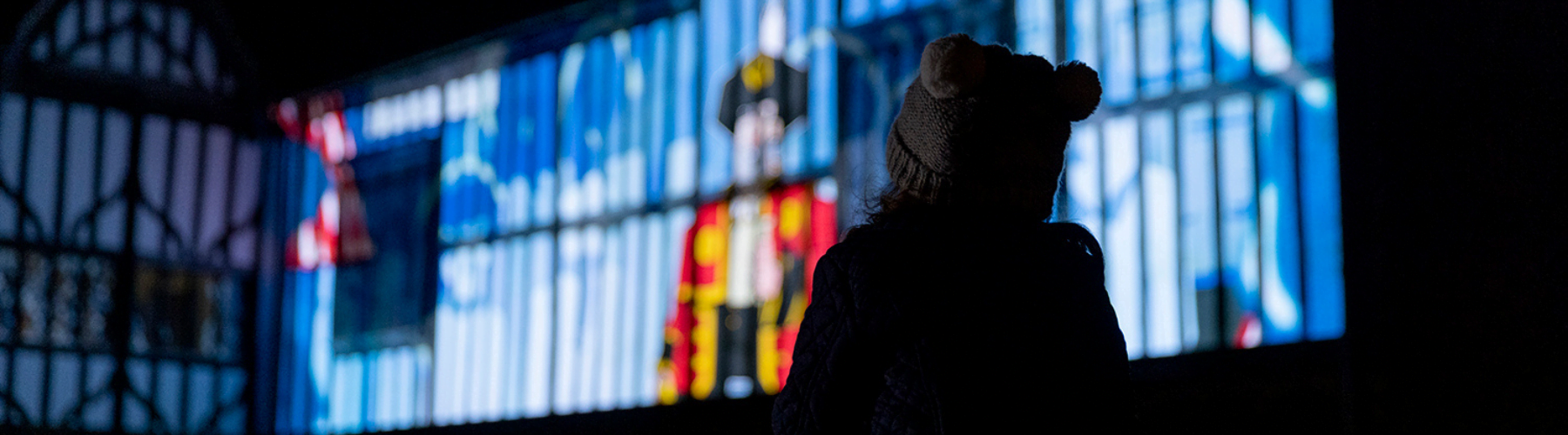 Girl watching Illuminate film projections on Gainsborough Old Hall