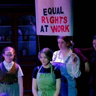 A group of young people holding a banner saying Equal rights at work.