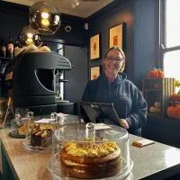 Ali standing behind the counter at Spokes Coffee Shop