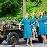 La Di Dahs in front of a jeep for Remembrance Day
