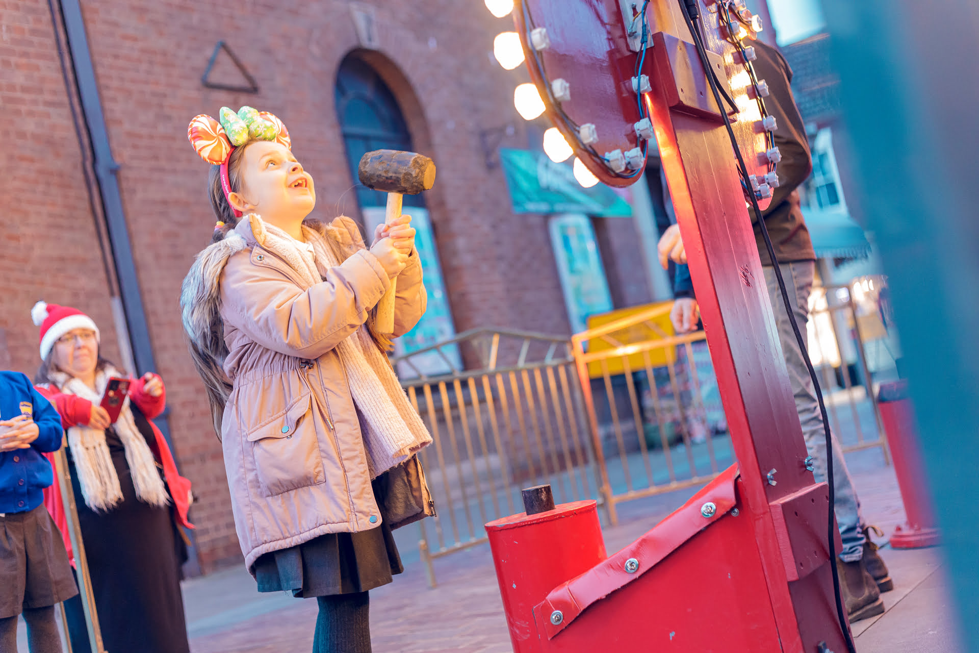 Christmas Lights Festival - Girl playing the high strike