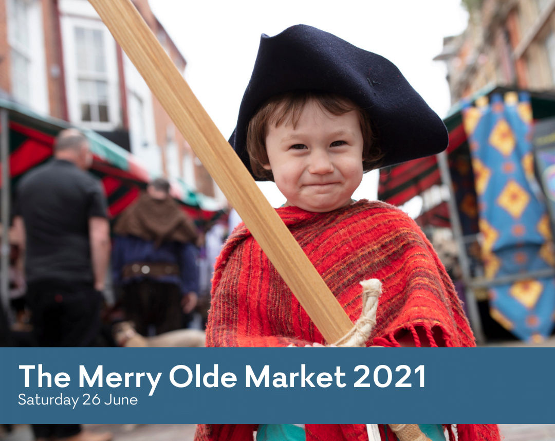 Boy dressed in costume holding a wooden sword at the Merry Olde Market in thriving Gainsborough.