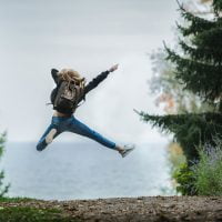 A person leaping in the air surrounded by trees - Gainsborough Farmers' Market