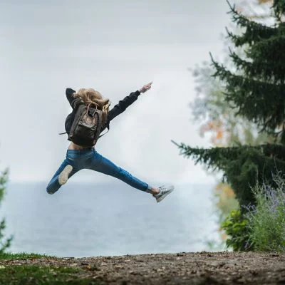 A person leaping in the air surrounded by trees - Gainsborough Farmers' Market