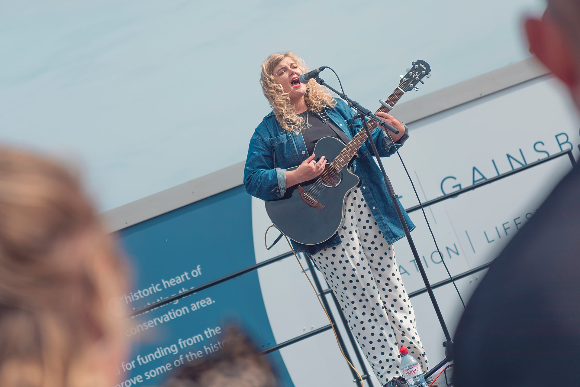 Lizzie Goddard singing and playing guitar at the Revive Festival