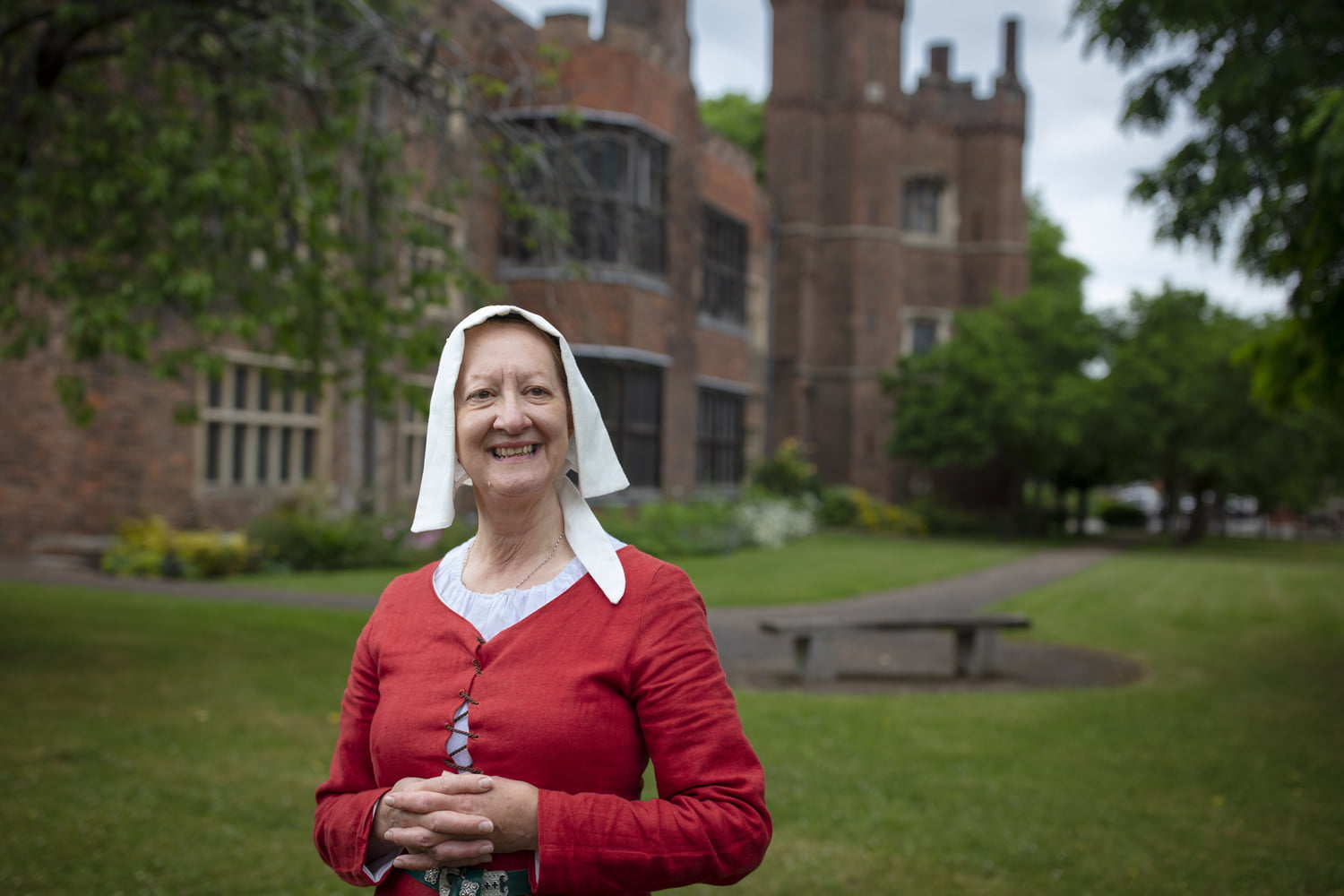 Woman in period costume stood outside Gainsborough Old Hall