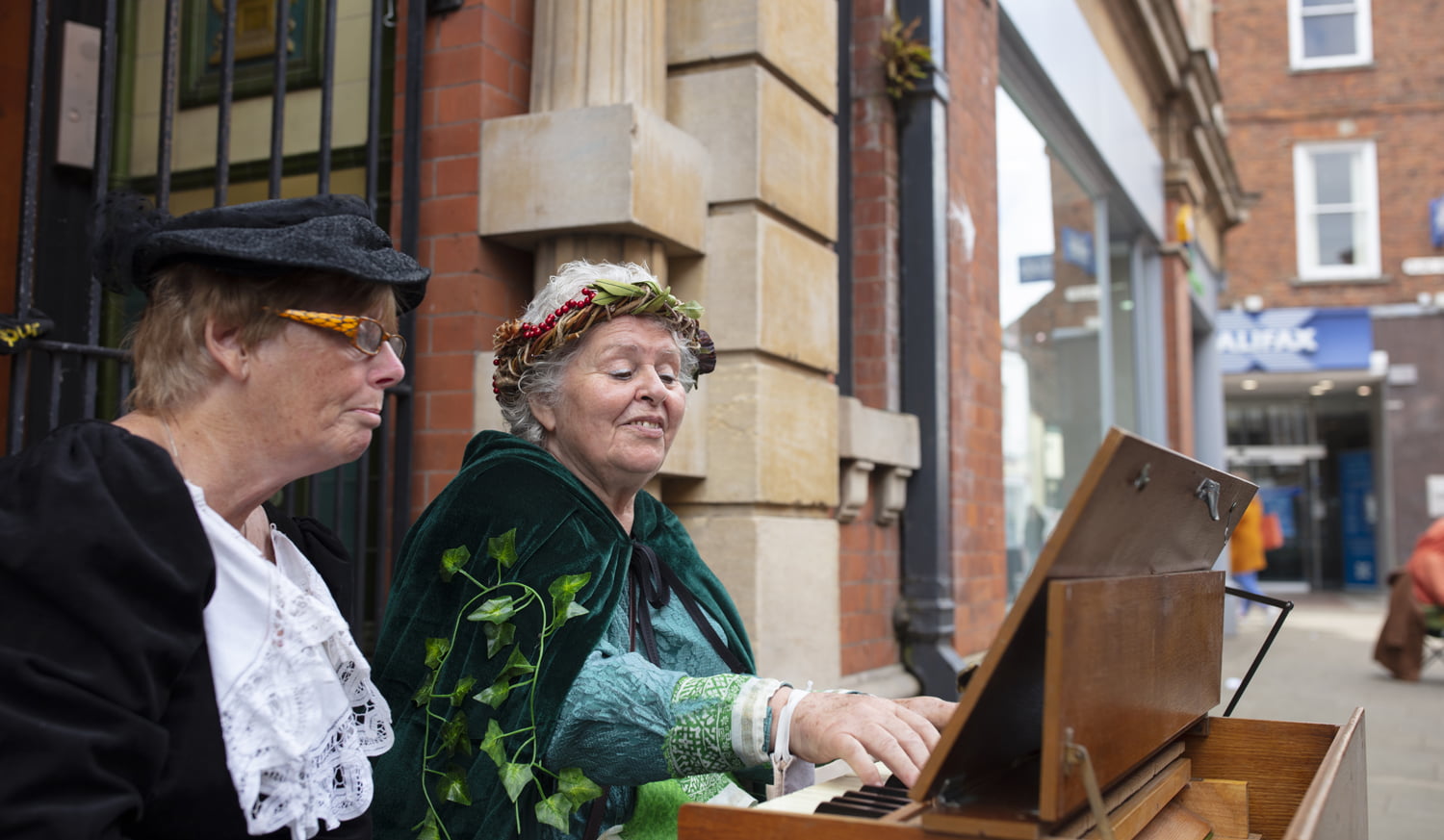 Two women playing the piano