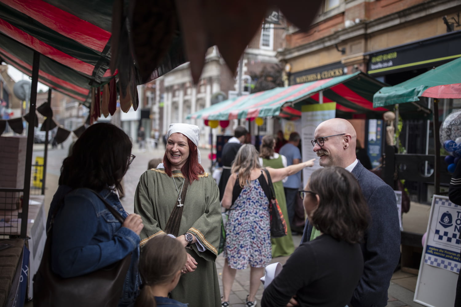 People in conversation at Merry Olde Market