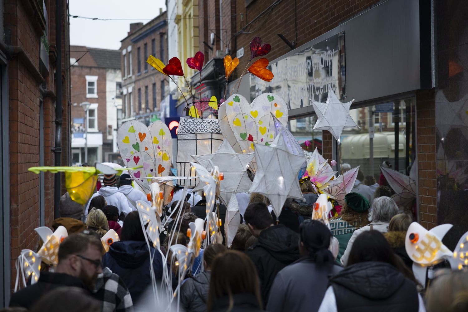 Illuminate 2024 lantern parade heading in to the market place.
