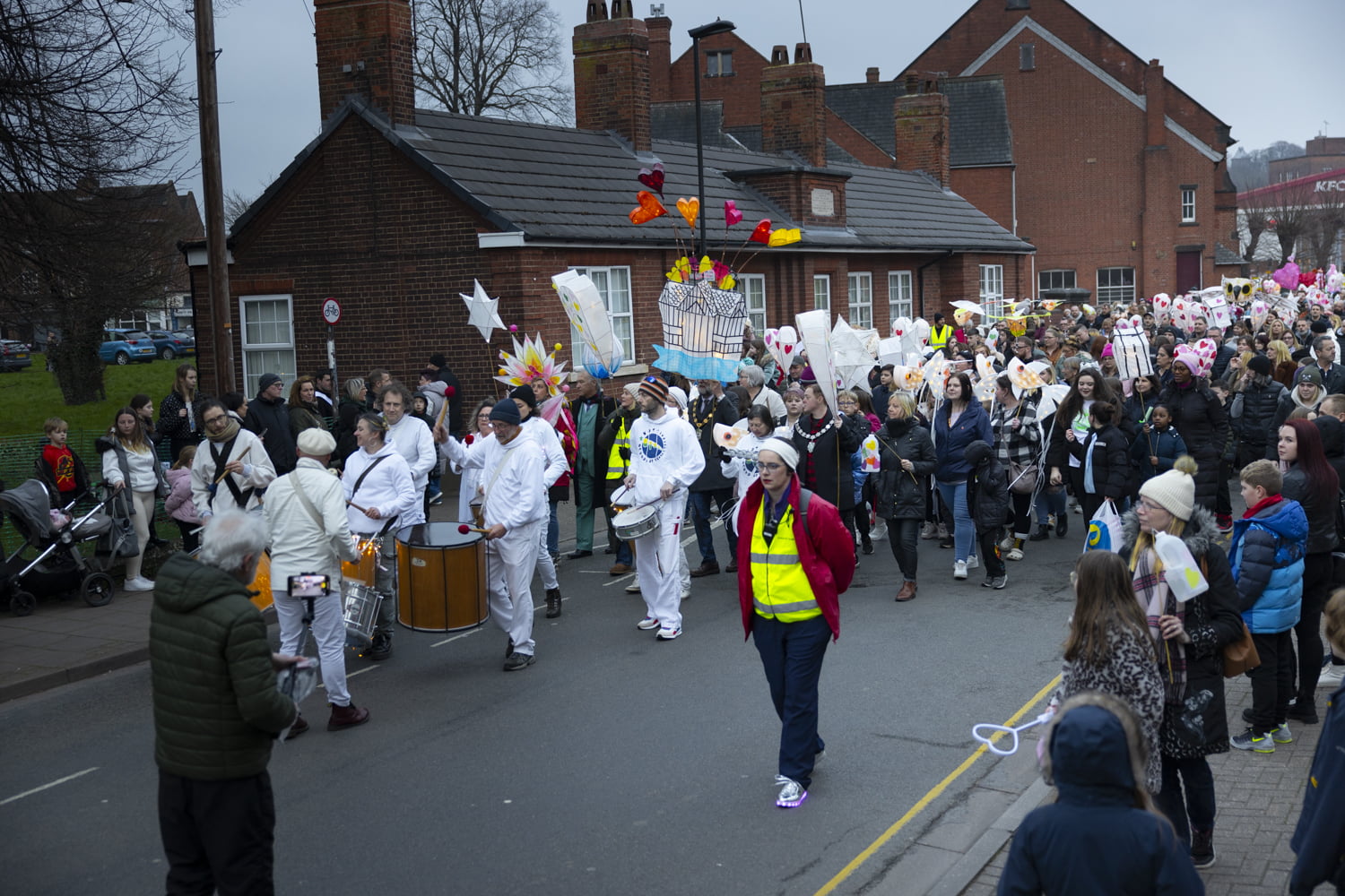 The Illuminate 2024 parade walking down Gladstone Street towards the Fire Garden.