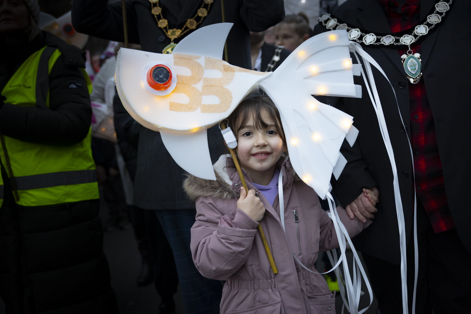 Girl holding fish lantern in the Illuminate 2024 parade.