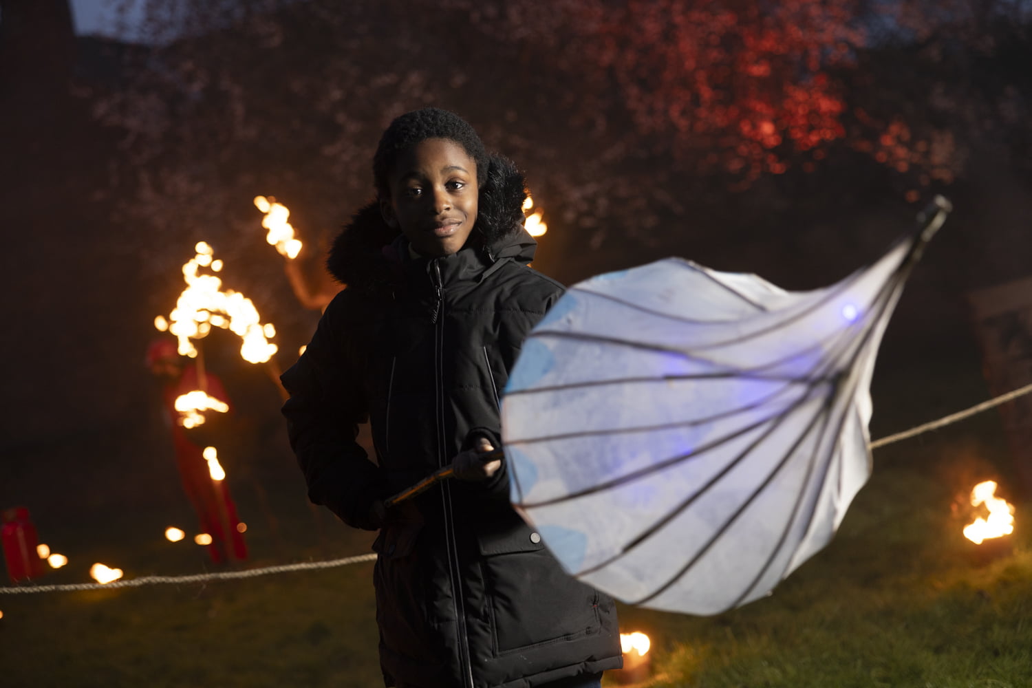 Boy holding large lantern in the Fire Garden at Illuminate 2024