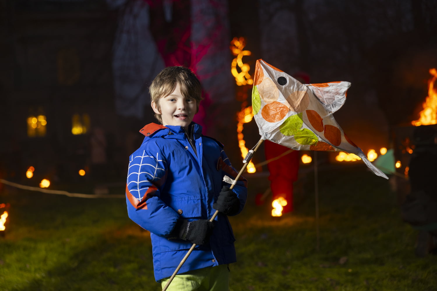 Boy holding large lantern in the Fire Garden at Illuminate 2024
