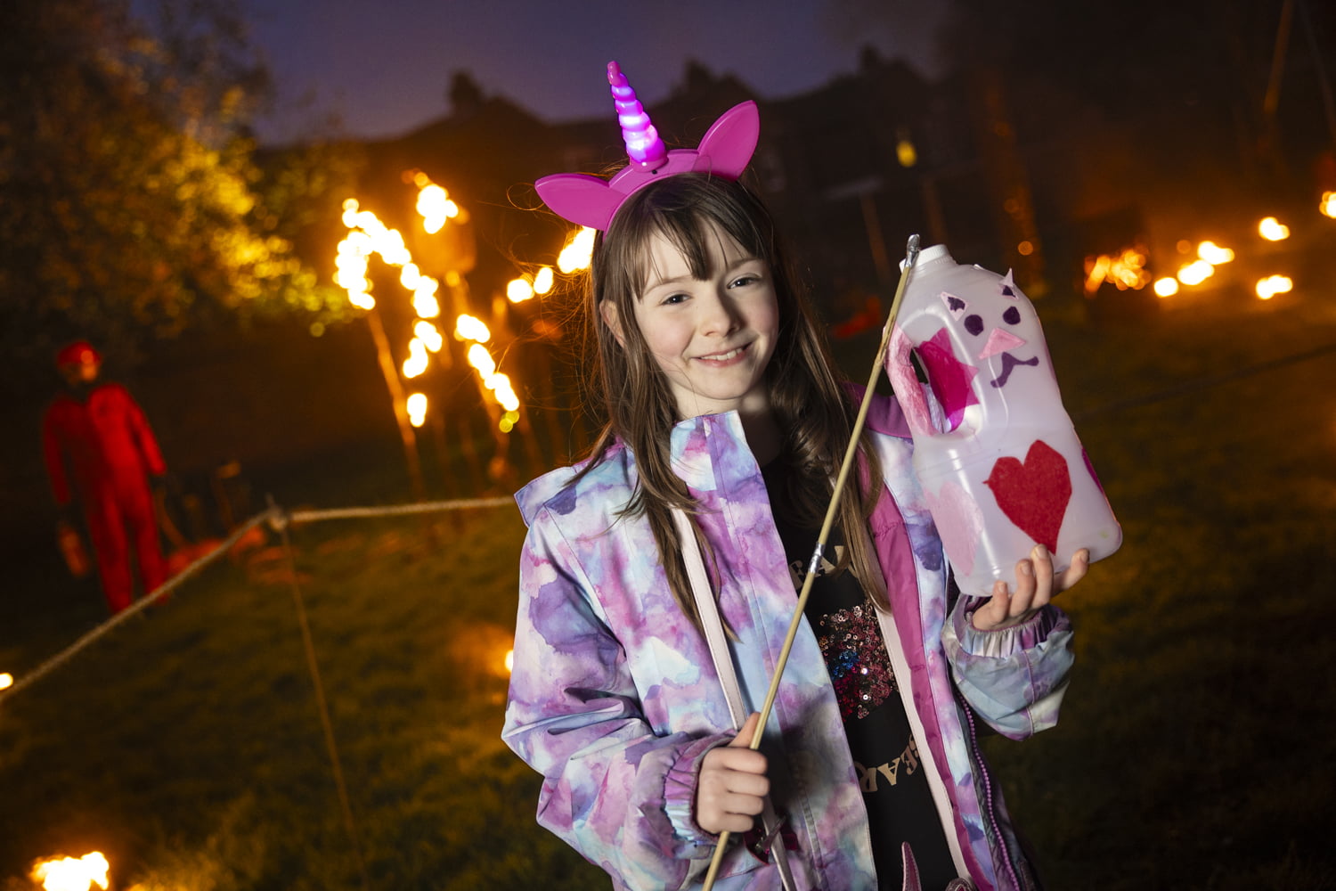 Girl holding homemade lantern in the Fire Garden at Illuminate 2024