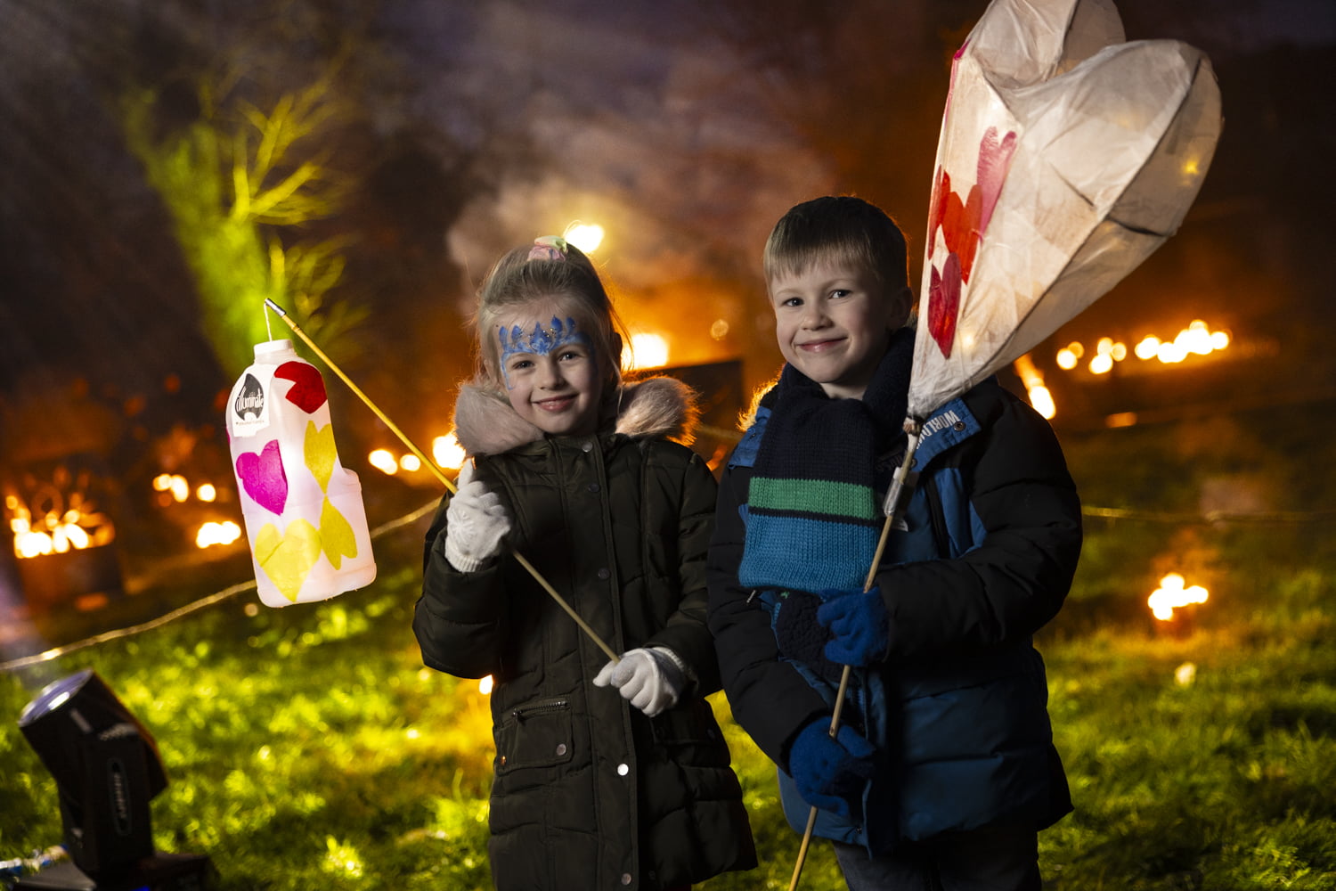 Boys holding lanterns in the fire garden at Illuminate 2024