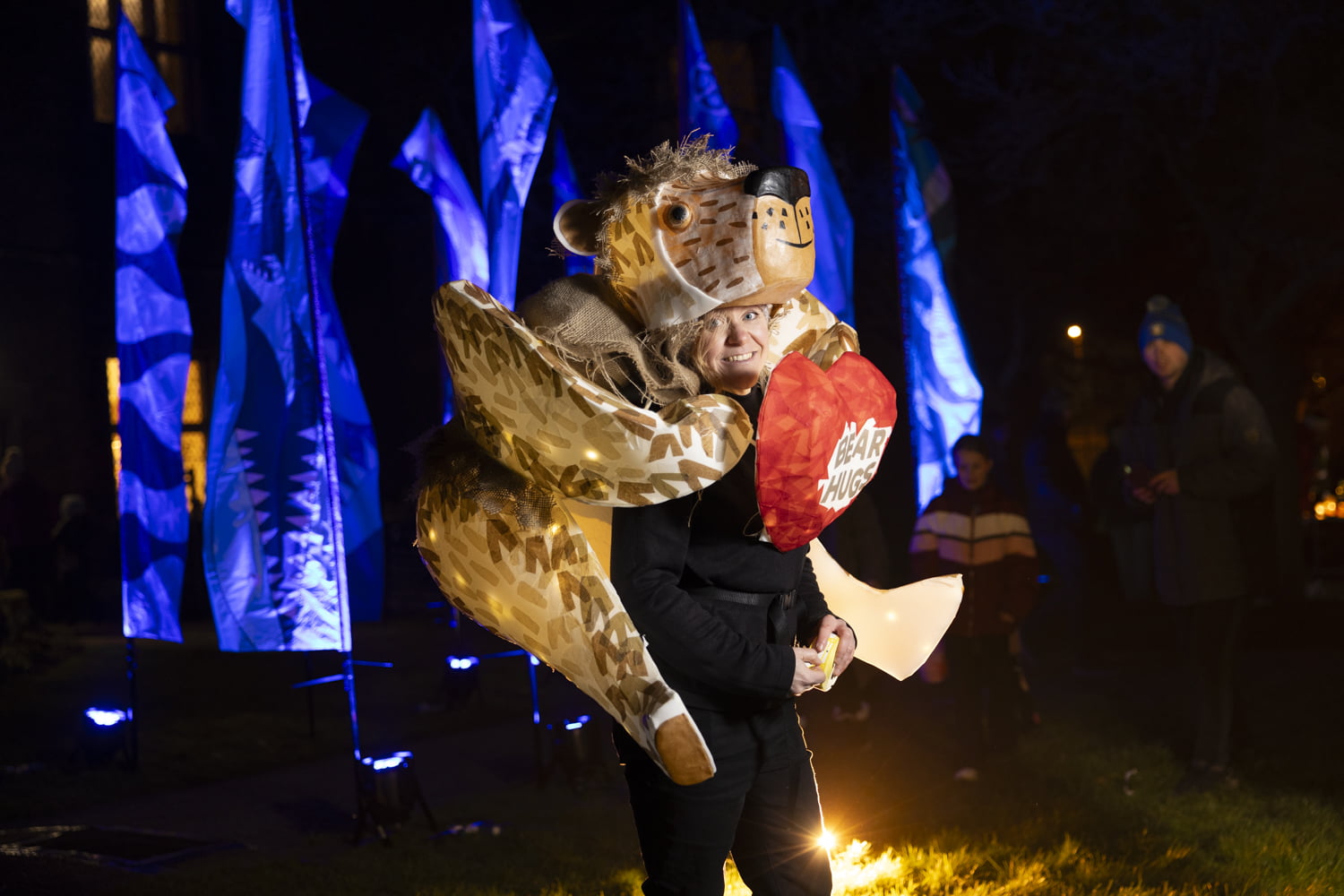 Woman wearing a lantern shaped like a bear on her back at illuminate 2024