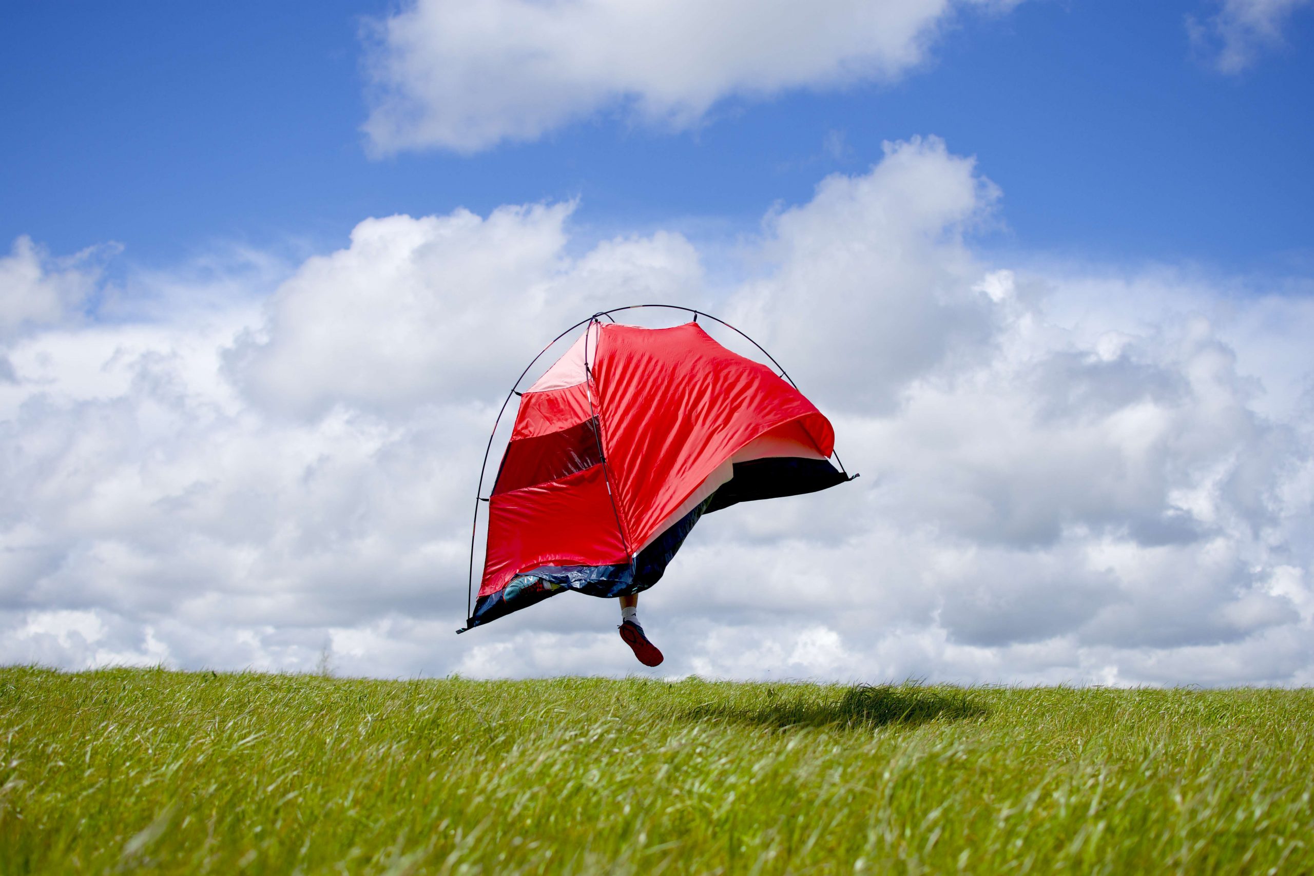 A person in a tent that is leaping off the ground