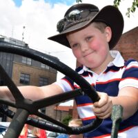 Tractor rally at Marshalls Yard and young fan Charlie trying out a Marshall's tractor