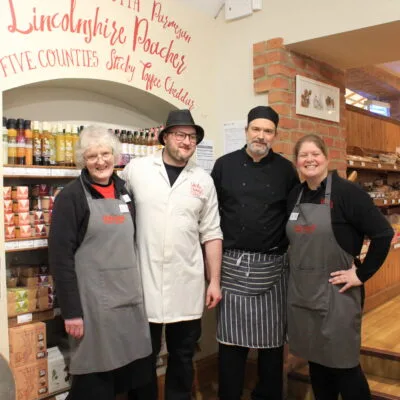 Warm welcome given by 4 smiling people in the shop